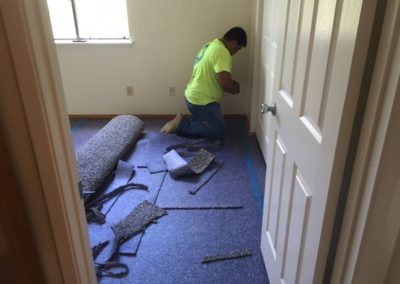 Installer Laying Carpet